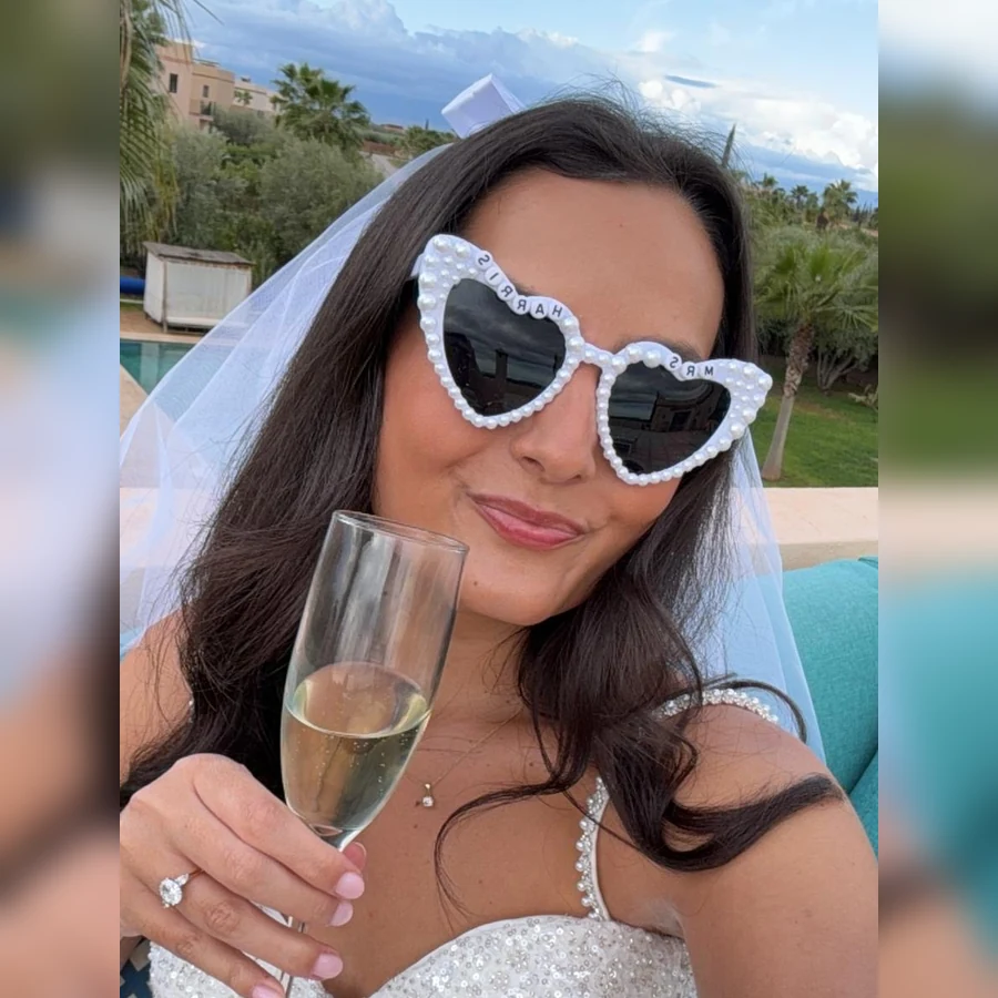 Claudia holding a glass of sparkling wine